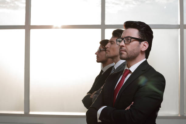 istock side view.a group of business people looking at a copy space 1007519368