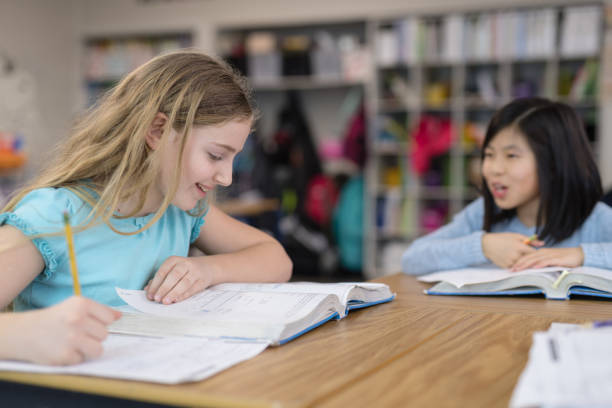 istock 4th grade girls studying in the classroom 1007522302
