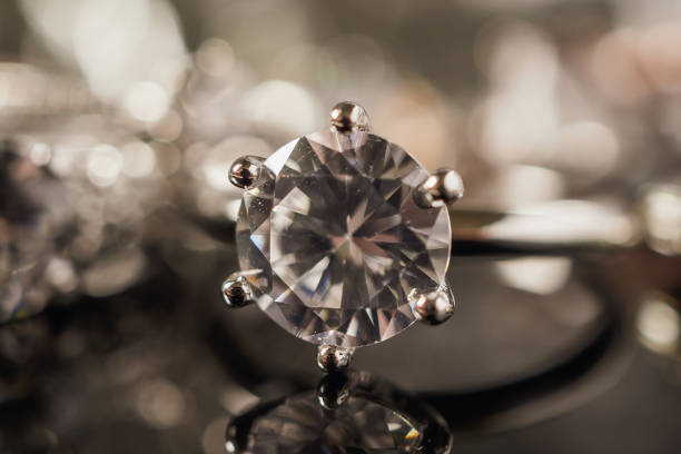istock Luxury Jewelry diamond rings with reflection on black background 1007524926