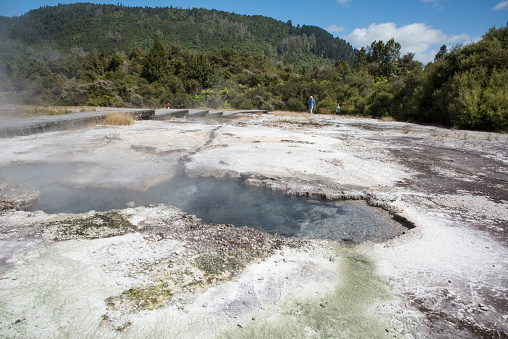Rotorua, North Island, New Zealand-December 16,2018: Tourists hiking through the natural hot spring with mineral deposits at the geothermal​ area Orakei Korako in Rotorua, New Zealand