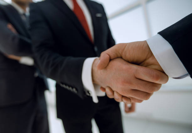 istock business background.business handshake business partners 1007530324