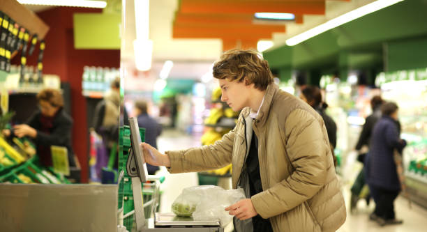 istock Young man buying vegetables at the market 1007540718