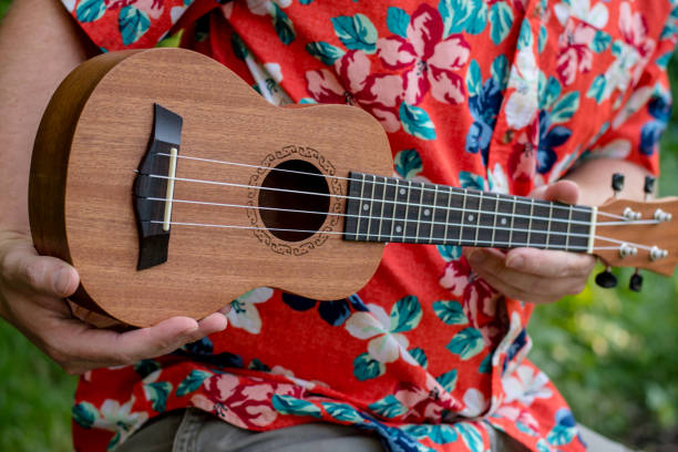 istock man with hawaiian shirt and ukulele 1007543006