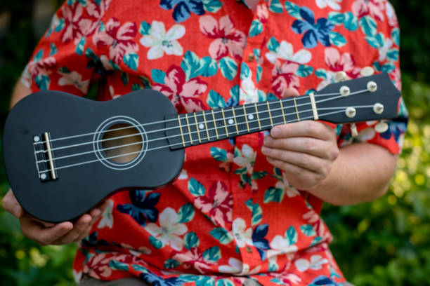 istock man with hawaiian shirt and ukulele 1007543012