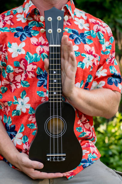 istock man with hawaiian shirt and ukulele 1007543014