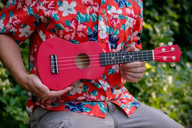 istock man with hawaiian shirt and ukulele 1007543020