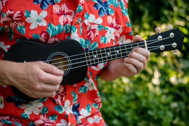 istock man with hawaiian shirt and ukulele 1007543022