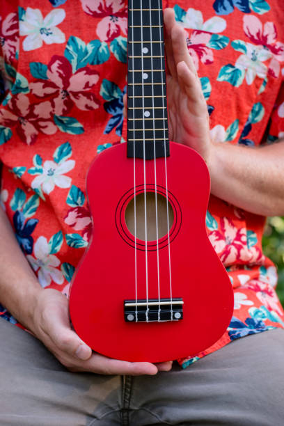 istock man with hawaiian shirt and ukulele 1007543024