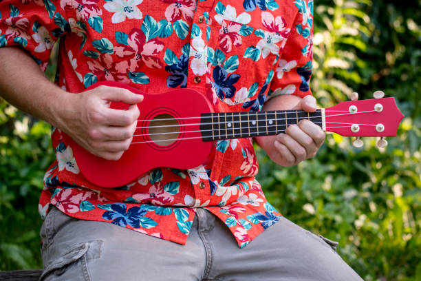 istock man with hawaiian shirt and ukulele 1007543026