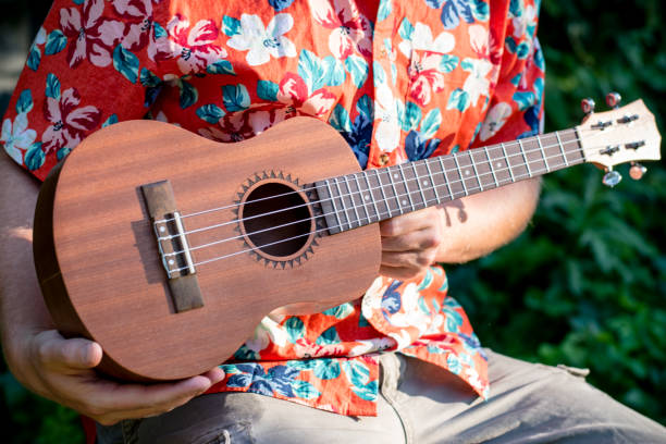 istock man with hawaiian shirt and ukulele 1007543044