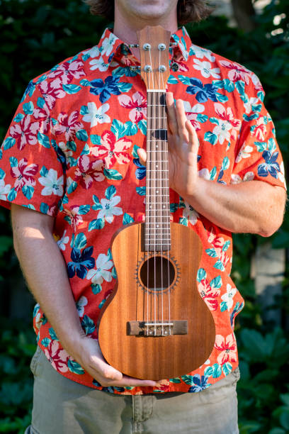 istock man with hawaiian shirt and ukulele 1007543054