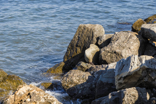 Sea waves are fighting against the big rocks on the shore