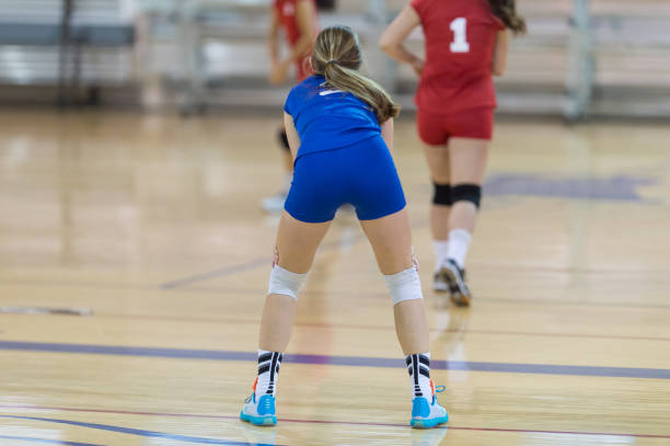 istock High school volleyball player waiting for the serve... 1007546460