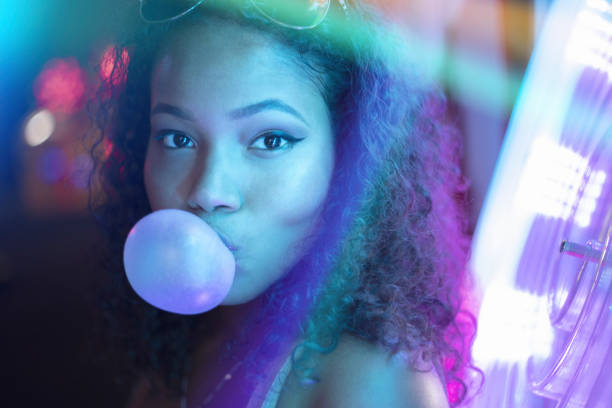 Neon Girl A stock photo of a young girl surrounded by neon lights and reflections. Photographed using the Canon EOS 1DX Mark II bubble gum photos stock pictures, royalty-free photos & images