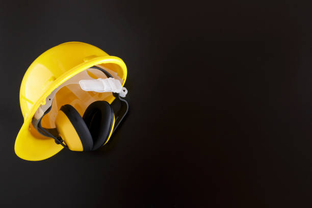 istock Earmuffs and Hard Hat on Black Background with Copy Space 1007556920