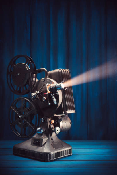 istock Film projector on wooden background 1007557200