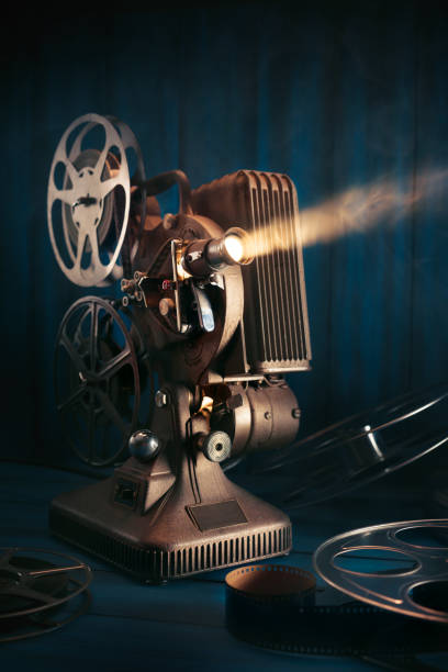istock Film projector on wooden background 1007557234