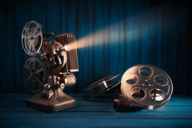 istock Film projector on wooden background 1007559266