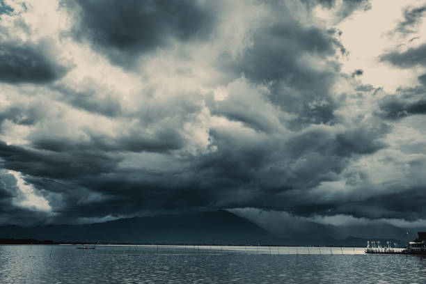 istock Storm cloudy sky raining over the mountain with lake river view nature landscape. 1007580198