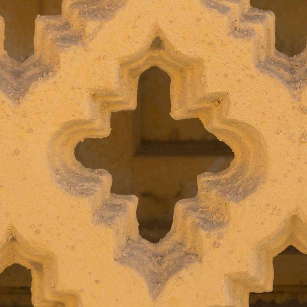 istock Close up, yellow concrete fence, textured architectural background. 1007585214