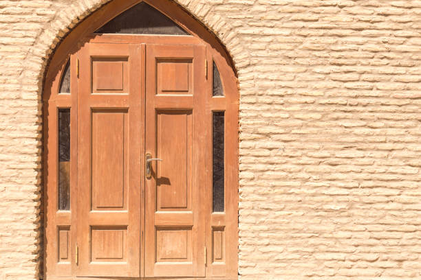 istock Old brick wall and the wooden closed door 1007585236