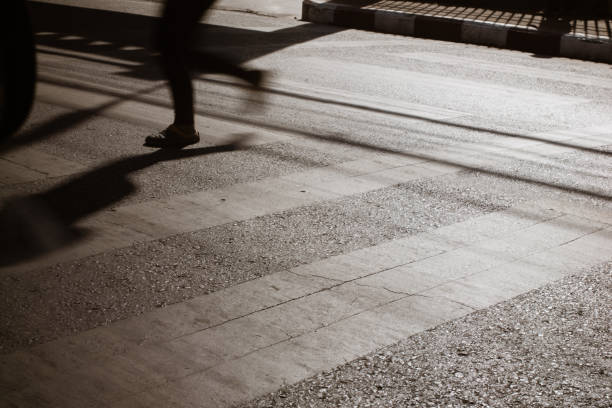 istock The zebra crossing with blurry walking pedestrians making long shadows on road 1007604714
