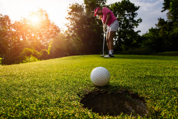 istock Golfer focus putting golf ball into the hole. 1007605130