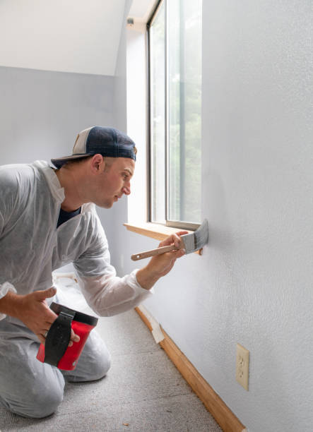 istock Man painting interior of home by window 1007605252