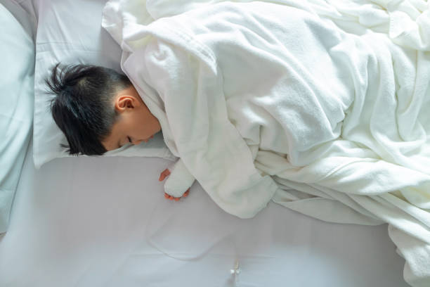 istock Asian patient boy lying at hospital 1007605400