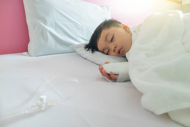 istock boy attaching intravenous tube 1007605426