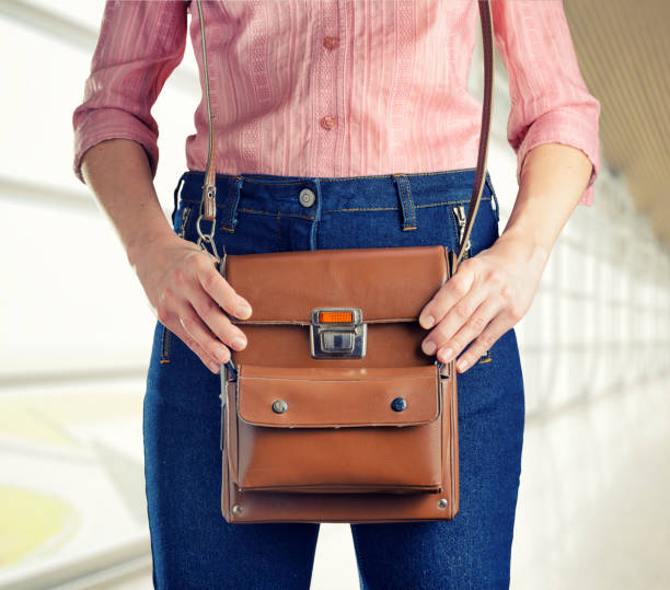 istock Young woman in deep blue jeans holding a bag 1007608184