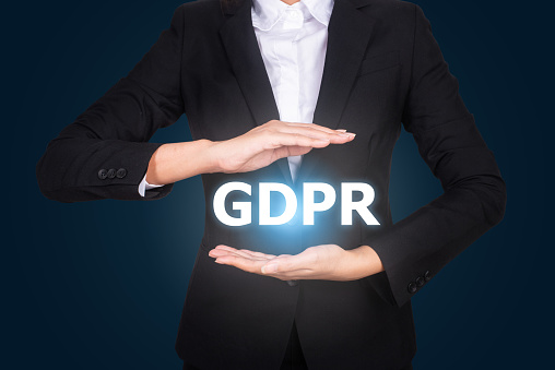 business in suit protecting word GDPR with hands, General Data Protection Regulation (GDPR)