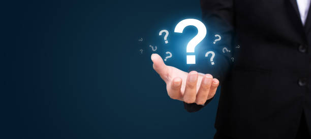 istock businesswoman on blurred background holding hand question marks 1007619034