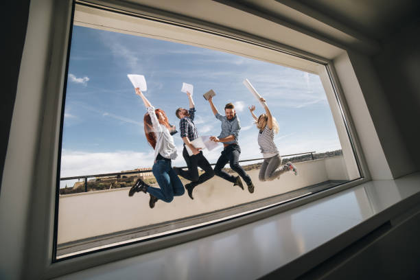 istock Team of successful creative people jumping of joy on a balcony. 1007627462