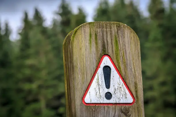 warning sign on timber post