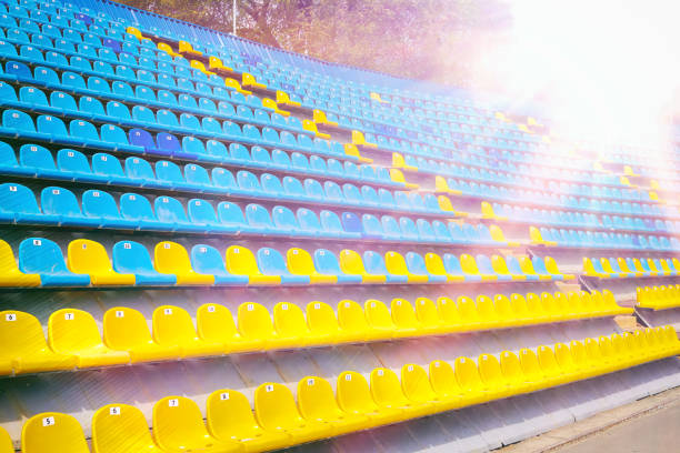 istock Yellow and blue plastic seats in the stadium 1007639762