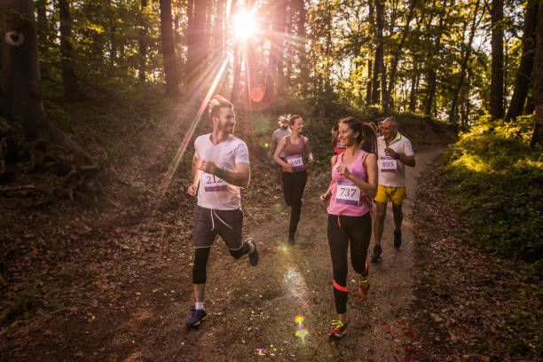 istock Happy athletic couple communicating while running a marathon in the forest. 1007643442