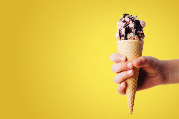 istock Vanilla Ice Cream Cone on Yellow with Space for Copy 1007646716