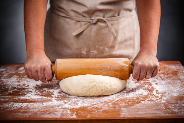 istock Housewife flattening a dough 1007648824