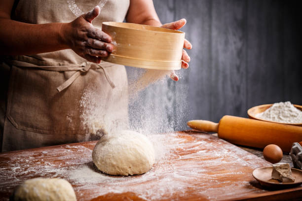 istock Woman hands sifting flour 1007649016