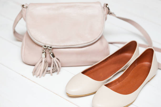 istock cross-body handbag and shoes on a white background 1007652010