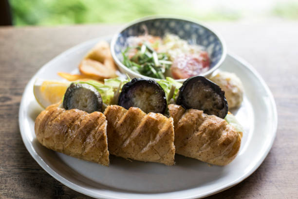 appetizing roll with grilled vegetables on wooden background