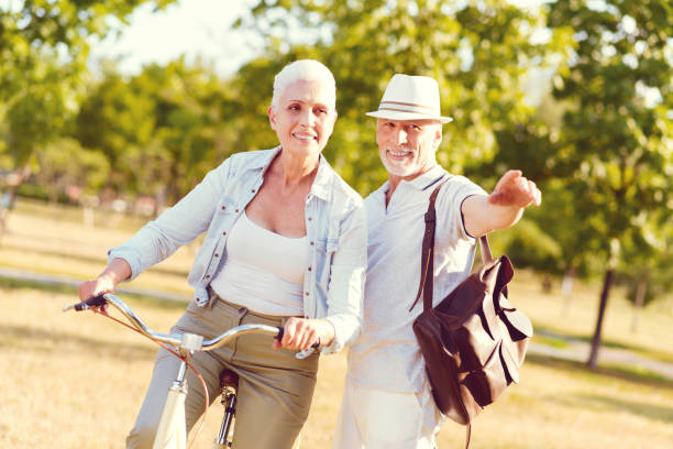 istock Supportive husband teaching his wife bicycling 1007658998