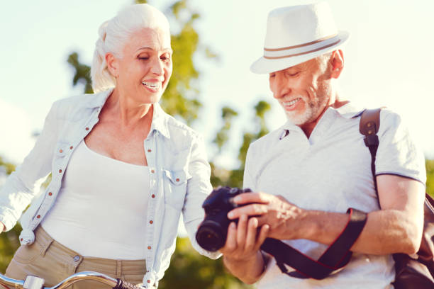 istock Radiant senior couple smiling while looking though photos 1007661614