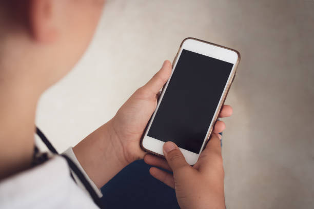 istock girl looking down on smartphone screen 1007665064
