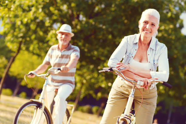 istock Joyful retired people taking break after bicycling in park 1007665430