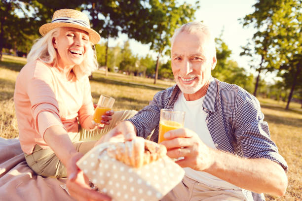 istock Radiant elderly family tasting chocolate croissant during picnic 1007672232