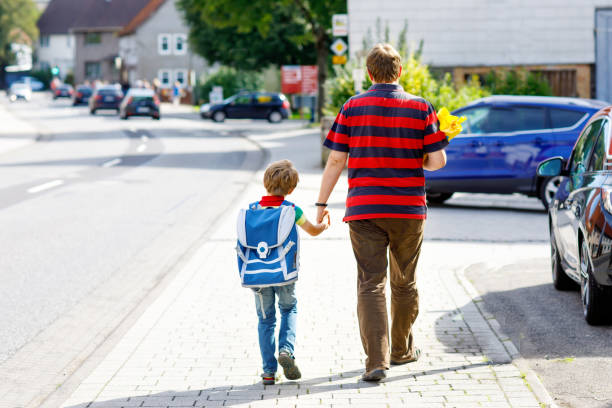 istock Young father taking child, kid boy to school on his first day 1007672680
