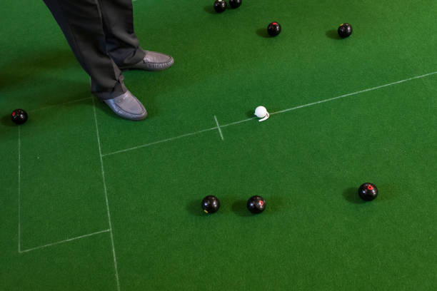 High angle view of a man's feet and bowling balls