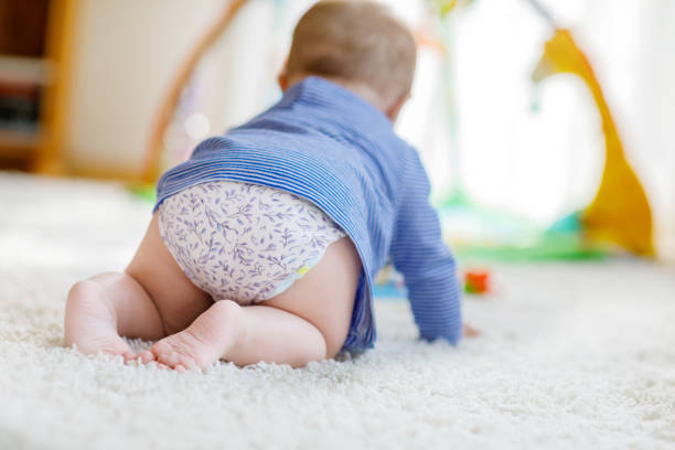istock Little cute baby girl learning to crawl. 1007675672